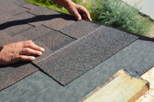 roofer working with shingles on colorado residential roof